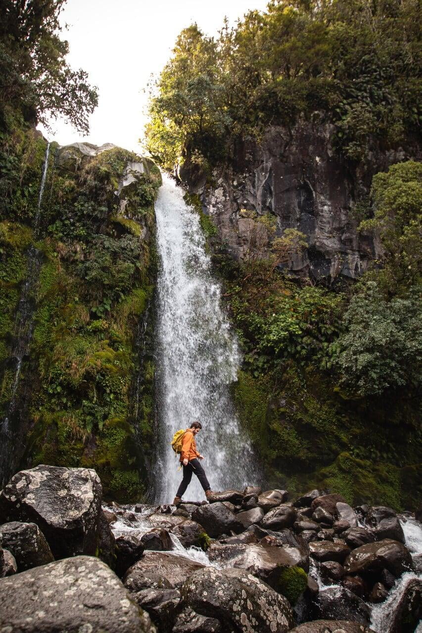 person in front of waterfall
